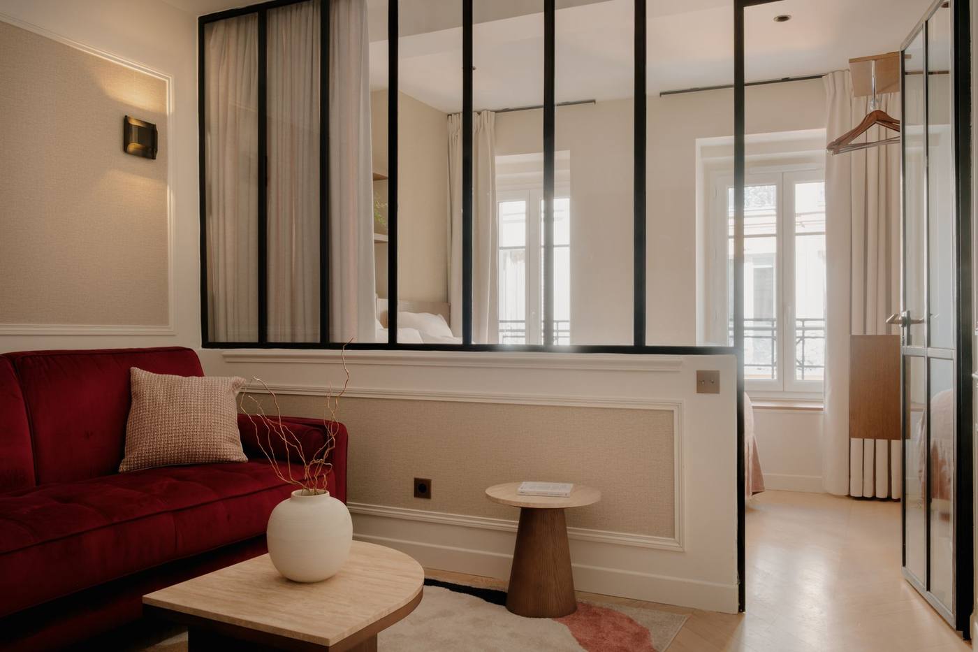 Suite 02 : canapé velours bordeaux devant la verrière